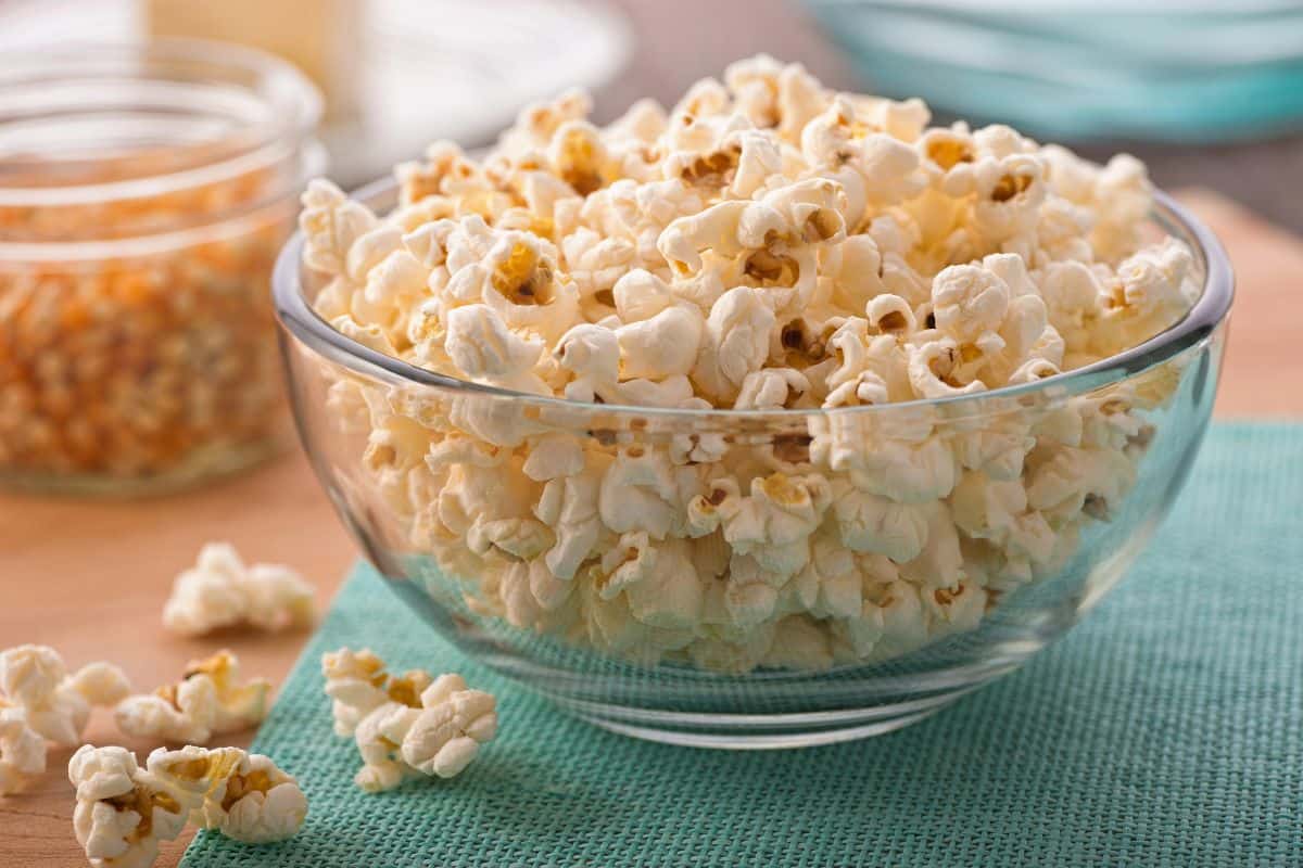 Bowl of plain popcorn on a table.