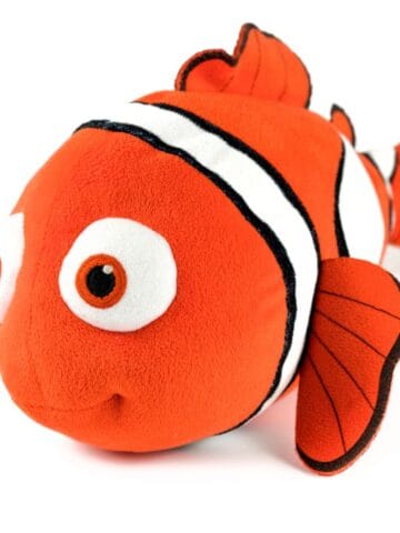 Orange clownfish stuffed toy isolated on a white background.