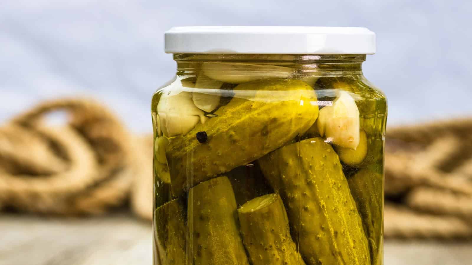 Jar of whole pickles in seasoned brine.